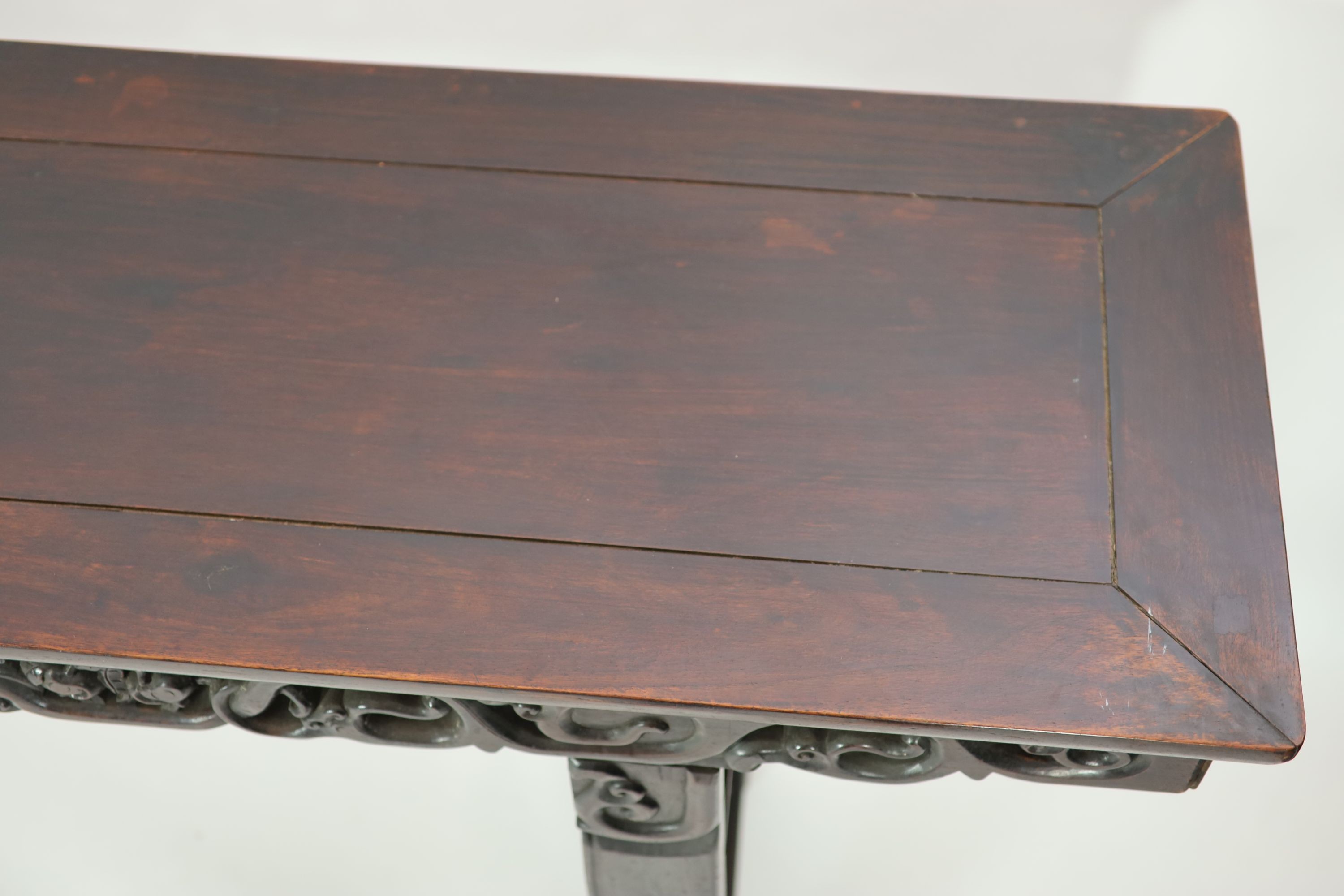 A large Chinese hongmu altar table, 19th century H 110cm. W 281cm. D 51.5cm.